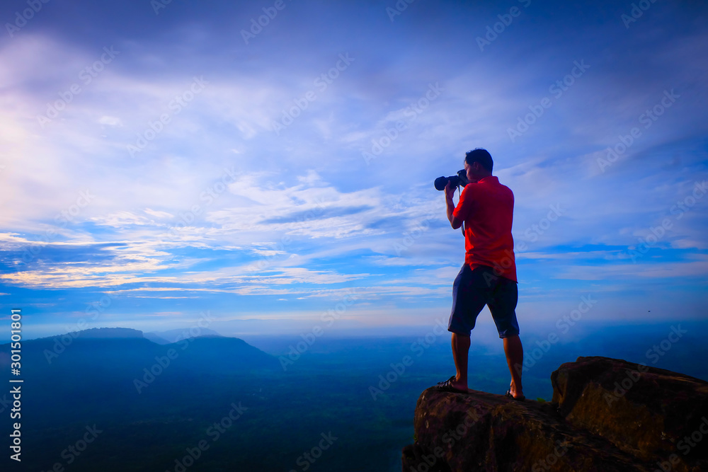 tourist Taking photos of the fog on the top of the mountain, relaxing, nature traveling concept.