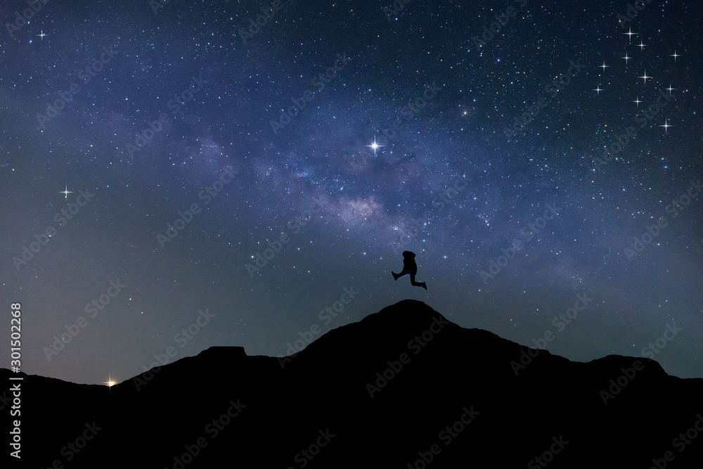 Fototapeta Traveler Man Silhouette Stand Top Mountain.Panorama blue night sky milky way and star on dark background.Universe filled , nebula and galaxy with noise and grain.