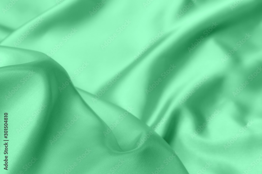 green satin fabric texture soft blur background green satin fabric texture soft blur background
