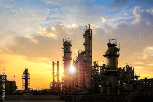 Oil and gas refinery plant or petrochemical industry on sky sunset background, Factory at evening, Manufacturing of petroleum industrial plant photo