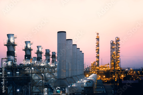 Factory of oil and gas refinery industrial plant with sunrise sky background, petrochemical industry, Smoke stacks of power plant photo