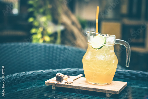 Honey and lemon iced tea with tiny dressert on the table. photo