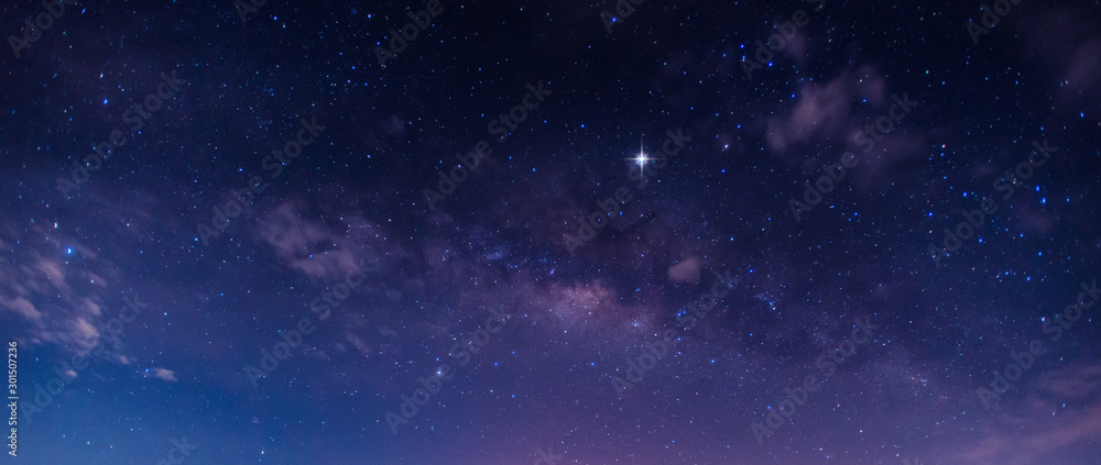 Panorama blue night sky milky way and star on dark background.Universe filled , nebula and galaxy with noise and grain.Photo by long exposure and select white balance.Dark night sky.