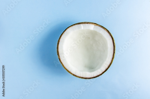 split coconut lies against a blue background