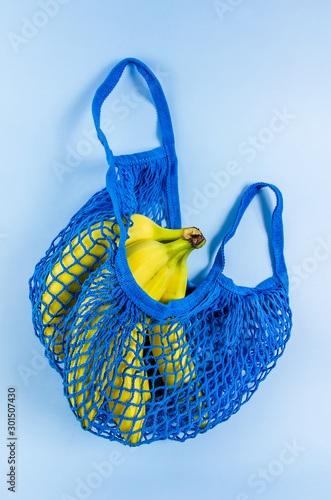 no plastic. babanas in a blue mesh bag