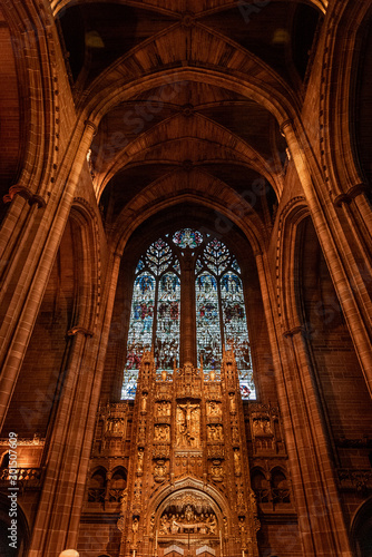 LIVERPOOL  ENGLAND  DECEMBER 27  2018  Magnificent stained glass from interior of the Church of England Anglican Cathedral of the Diocese of Liverpool with biblical sculptures of jesus christ.