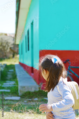 Little girl is going to rural school. photo