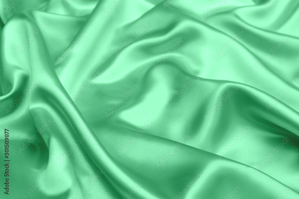 Fototapeta premium green satin fabric texture soft blur background