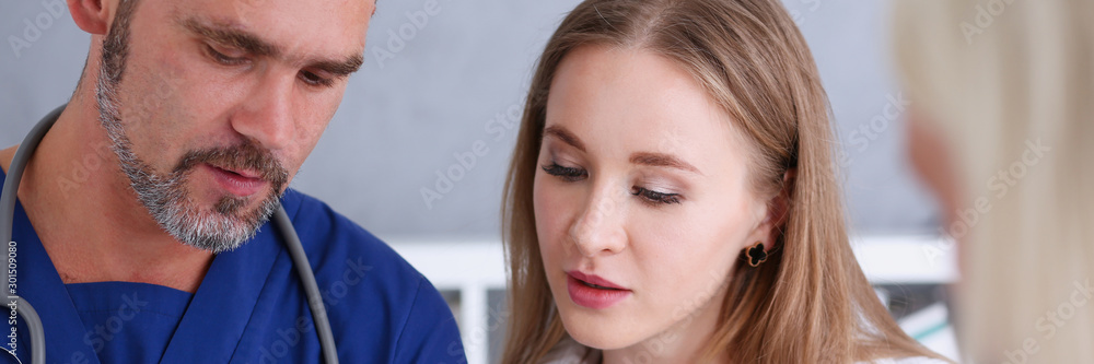 Fototapeta premium Concerned handsome doctor communicate with patient