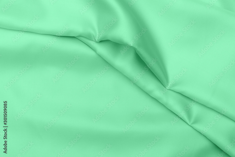green satin fabric texture soft blur background green satin fabric texture soft blur background