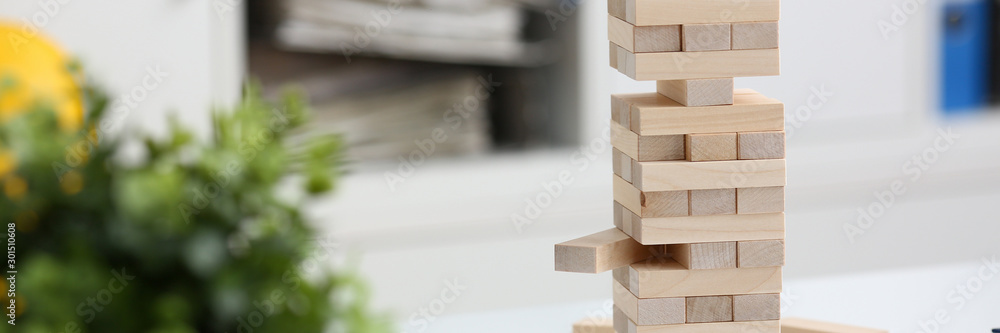 Businessman plays in a strategy of jenga hand Businessman plays in a strategy of jenga hand