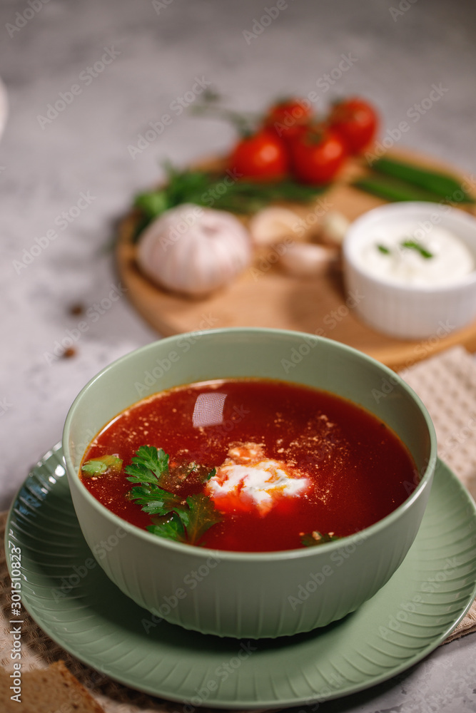 Beetroot soup with sour cream and herbs in a plate, close-up. Tasty and hearty dinner, borsch with vegetables. Still life Beetroot soup with sour cream and herbs in a plate, close-up. Tasty and hearty dinner, borsch with vegetables. Still life