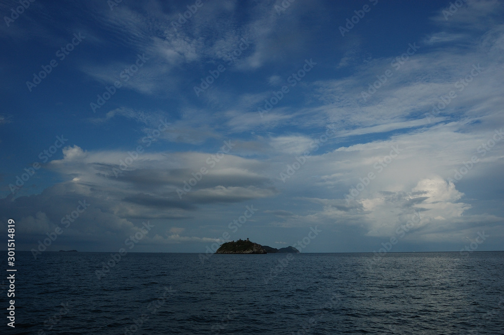 Beautiful clouds over an island on the way from Koh Tao to Chumphon, Thailand