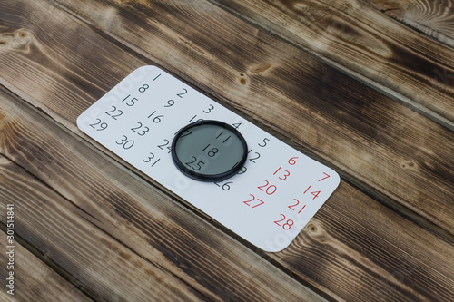 Calendar and filter grey on wood photo