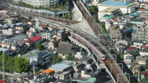 Train passing throuh a town in Tokyo photo