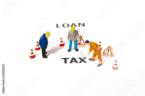 Miniature people with letter TAX. using as background business concept and finance concept with copy space for your text or design.