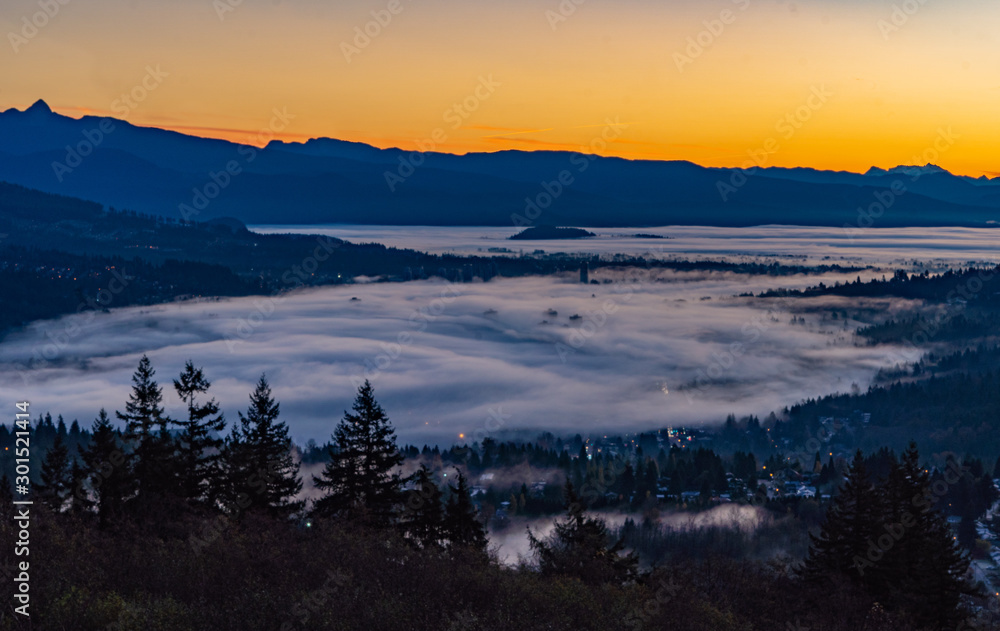 Tos of high rise condos just peeking through cloud inversion over Port Moody at sunrise