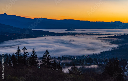 Tos of high rise condos just peeking through cloud inversion over Port Moody at sunrise