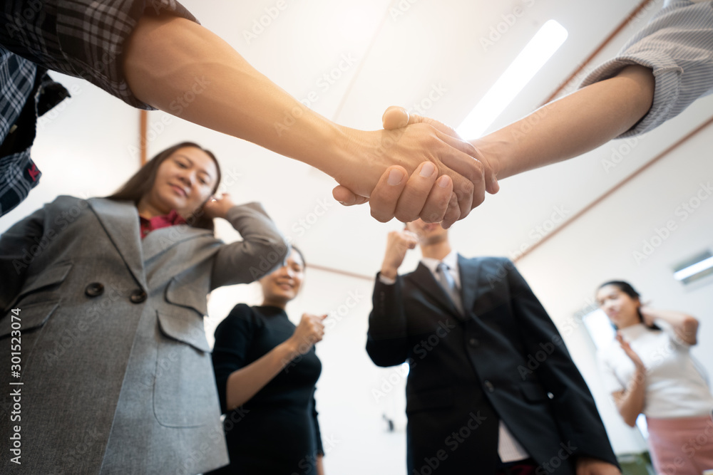 Group of  business  shake hands when completing the assignment task.