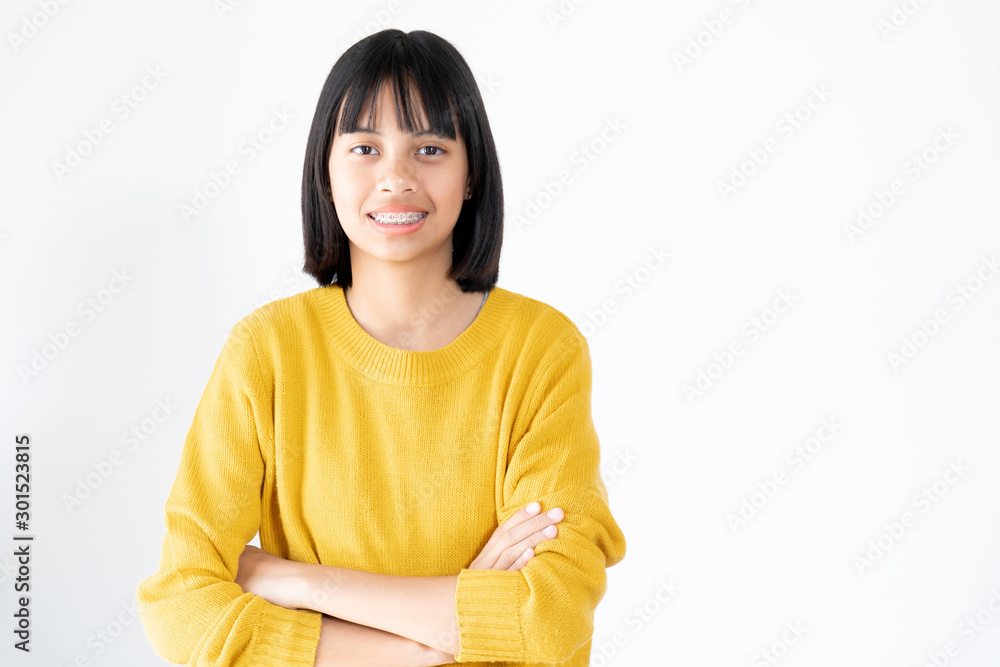 Portrait of Girl Wearing Yellow Swather with Attractive Black Eyes and Dental Brace Smiling and Happy on White Background Portrait of Girl Wearing Yellow Swather with Attractive Black Eyes and Dental Brace Smiling and Happy on White Background