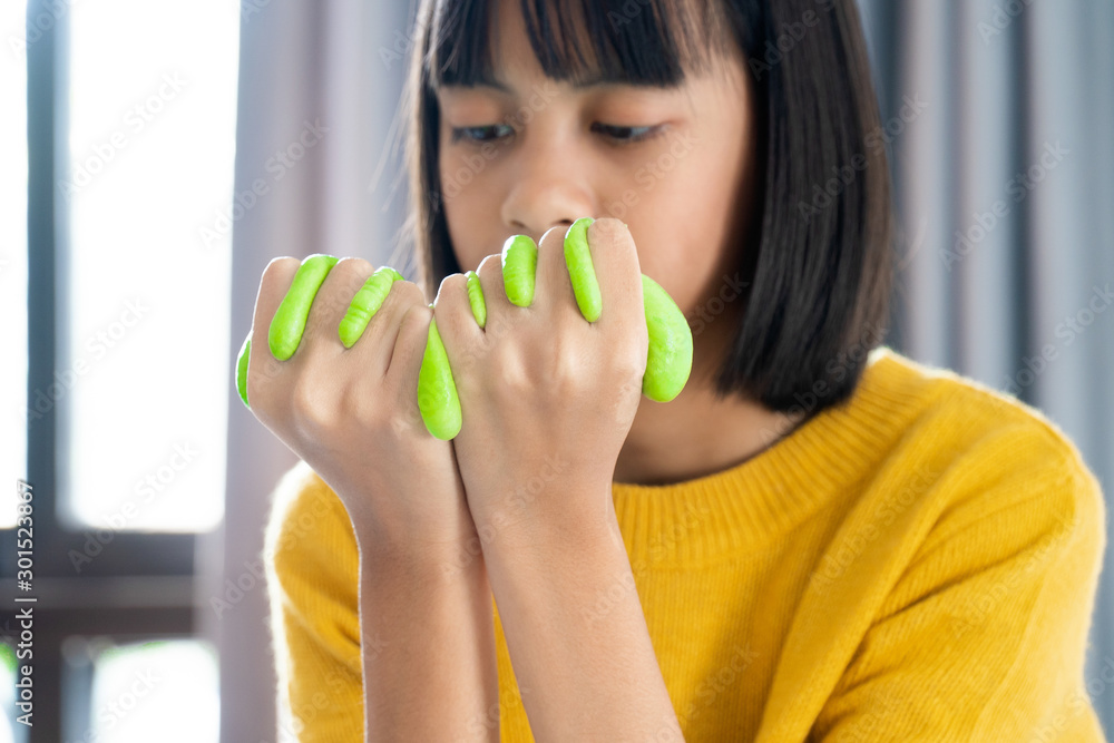 Hand Holding Homemade Toy Called Slime, Kids having fun and being creative by science experiment Hand Holding Homemade Toy Called Slime, Kids having fun and being creative by science experiment