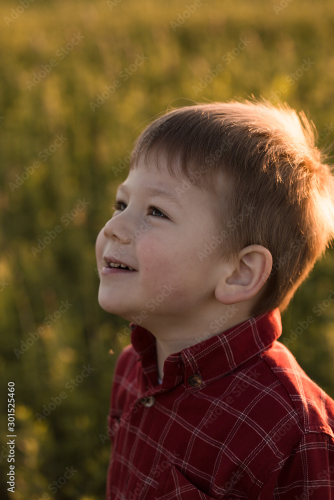 portrait of happy smiling cute little caucasian child on summer sunset outdoors portrait of happy smiling cute little caucasian child on summer sunset outdoors