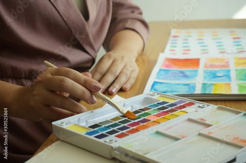 Watercolor paints and brushes workplace artist with artistic tools for mock up.Creative Design Concept.