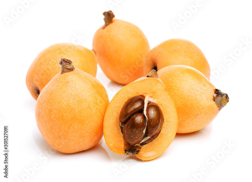 Close up view of some loquat fruit isolated on a white background