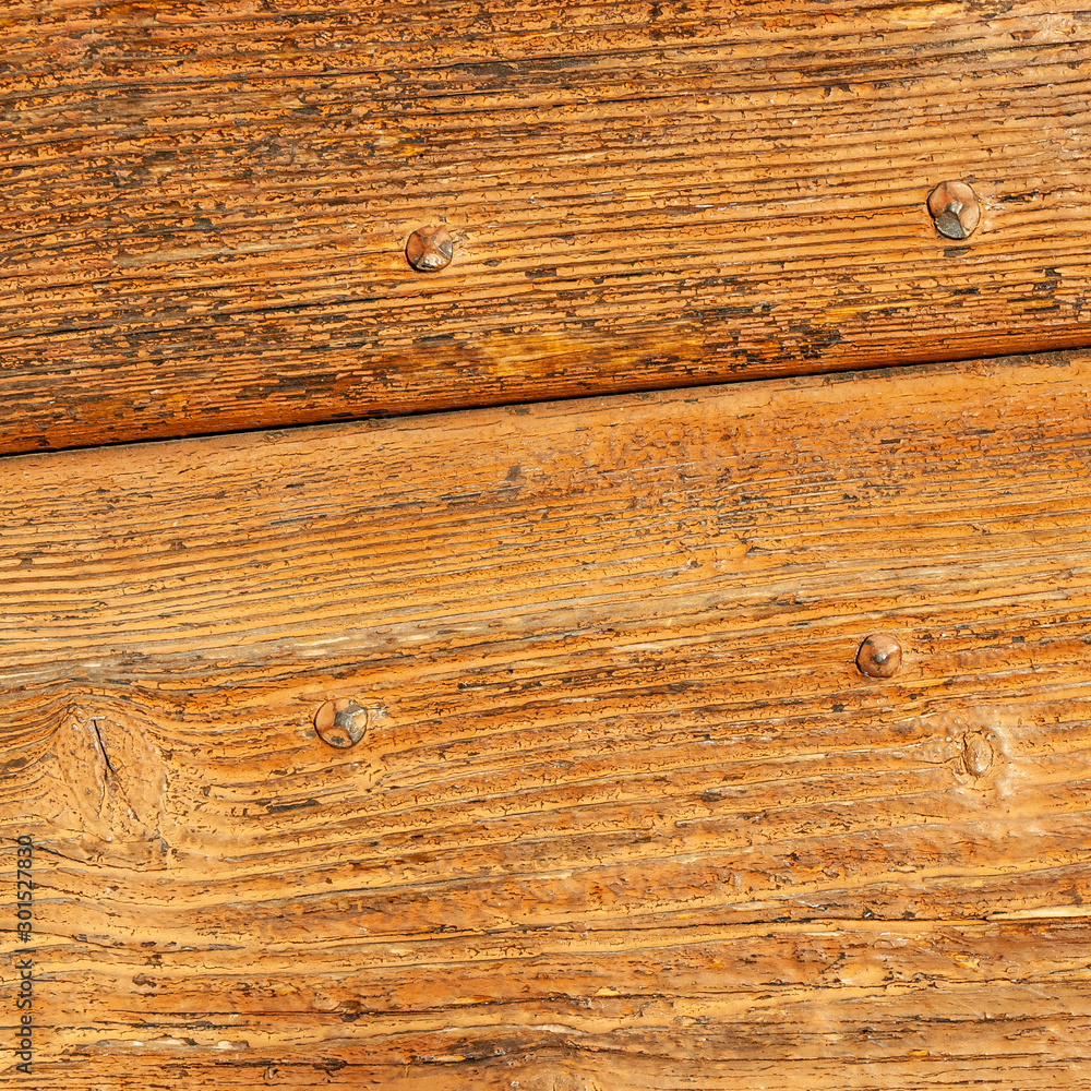 Obraz premium Wooden panels of rural house door, Italy. Textures in wood painted with traditional colors of country houses, cracked and ruined by time.