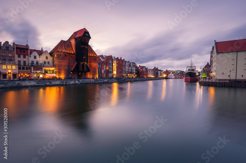 Old town and medieval crane in Gdansk evening cityscape.