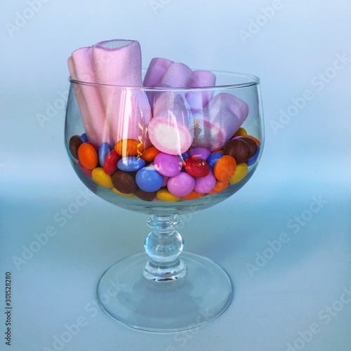 Delicious Marshmallows and sweet small candies in a glass bowl