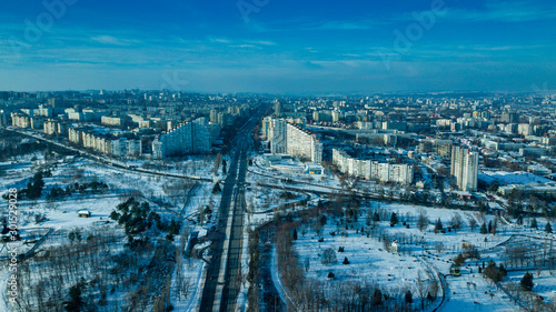Top view of city in winter at sunset on sky background. Aerial drone photography concept.