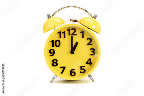 Yellow alarm clock on white at 1 o'clock