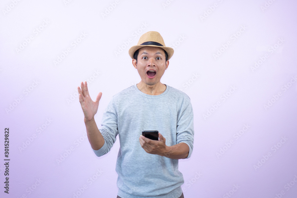Happy asian man shopping with smart phone on pink background. Happy asian man shopping with smart phone on pink background.