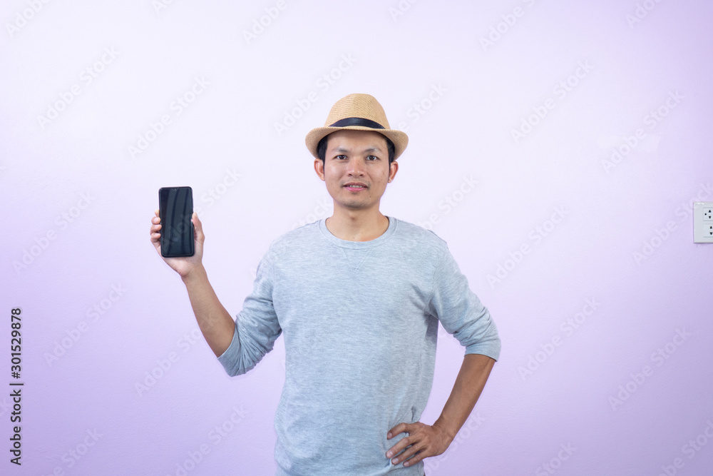 Happy asian man shopping with smart phone on pink background. Happy asian man shopping with smart phone on pink background.