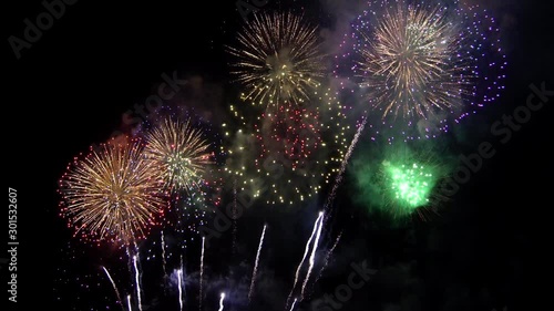 4K Beautiful colorful holiday fireworks on the black sky background
