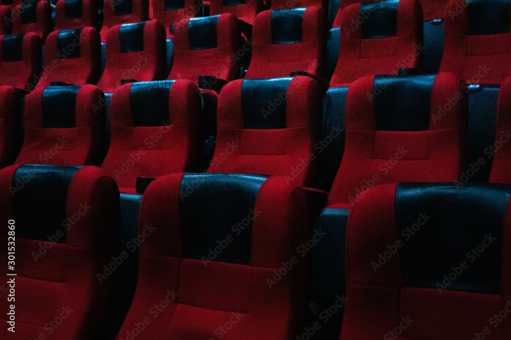 empty seats in the cinema hall. Rows of traditional red covered chairs, movie theater. empty seats in the cinema hall. Rows of traditional red covered chairs, movie theater.