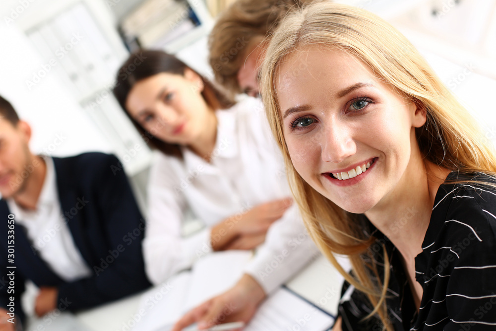 Beautiful smiling cheerful girl at workplace look in camera Beautiful smiling cheerful girl at workplace look in camera