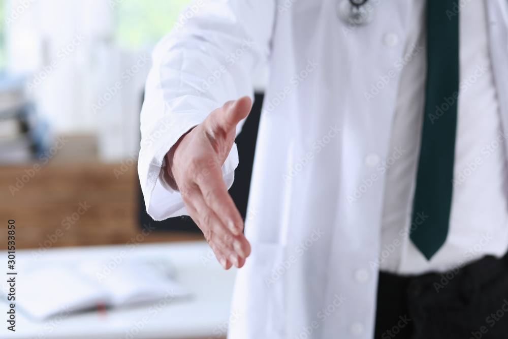 Male medicine doctor hold pad and give arm to shake Male medicine doctor hold pad and give arm to shake