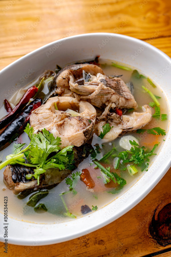 Tom Yum Snakehead Fish,Tom Yum Snakehead fish on Thai tableware In a bowl on a white ground for design in Thai food concept Tom Yum Snakehead Fish,Tom Yum Snakehead fish on Thai tableware In a bowl on a white ground for design in Thai food concept