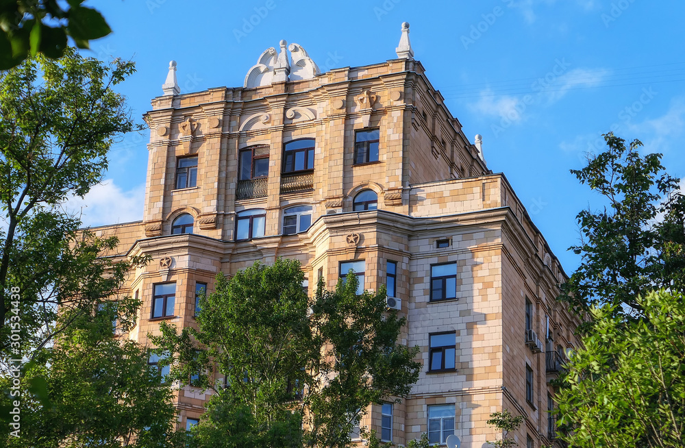 Fototapeta premium Old architecture in sunny Moscow framed with green tree branches