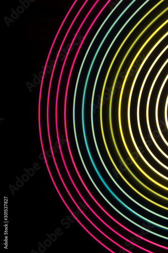 Multicolor light circles on a black background.