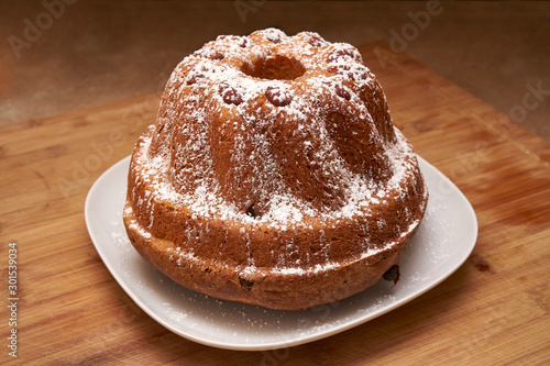 Kugelhopf Cake Powered With Icing Sugar On A Wooden Board