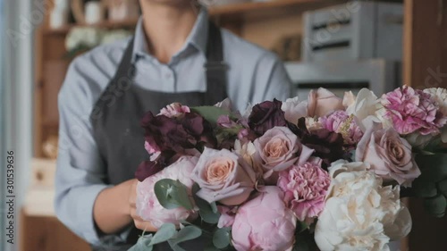 Florist making fresh flower bouquet in flower shop