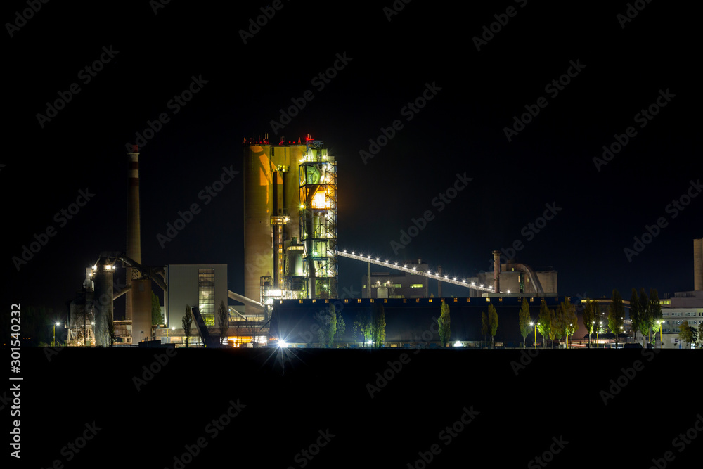 modern factory exterior at night, cement production