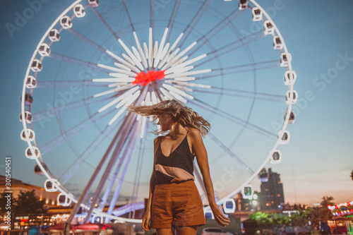 young woman shaking her head on a ferris wheel