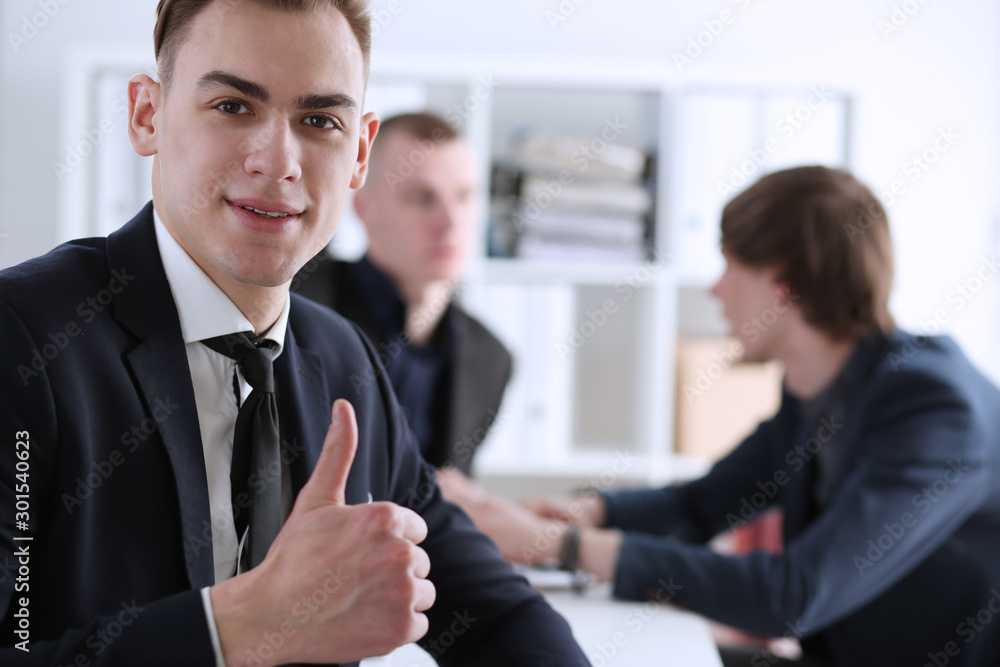 Male hand showing OK or approval sign with thumb up Male hand showing OK or approval sign with thumb up