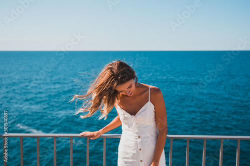 happy woman smiling in front of the ocean