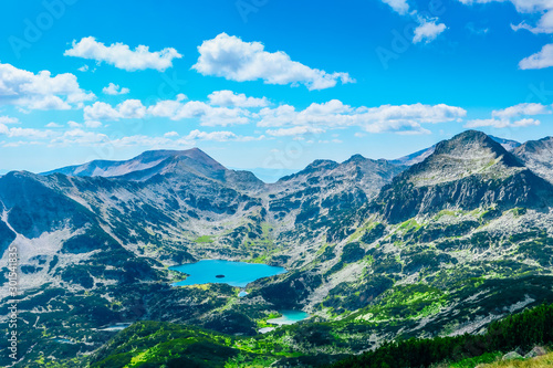Mountain tops marvelous panorama, calm and beautiful sky, lake. Alpine scenery landscape, rocky hills.