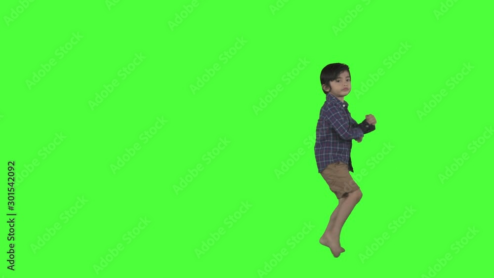 Attractive little boy dancing in the studio with green screen background. Shot in 4k resolution Attractive little boy dancing in the studio with green screen background. Shot in 4k resolution